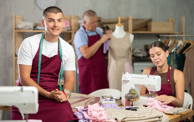 Guy fashion designer is in office. Production of clothes according to individual measurements,...