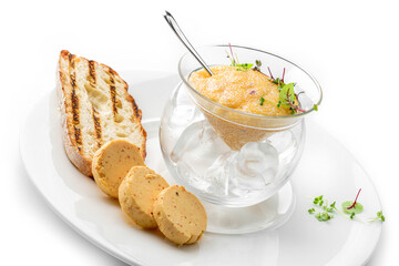 Delicious yellow caviar in a bowl with croutons and butter on plate isolated on white background. Fish and seafood, close up, top view