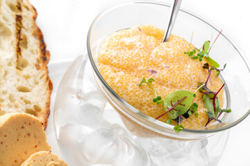 Delicious yellow caviar in a bowl with croutons and butter on plate isolated on white background. Fish and seafood, close up, top view