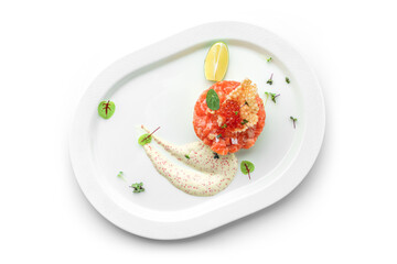 Tartar with salmon fish, avocado and red caviar decorated with microgreens on plate isolated on white background. Fish and seafood, close up, top view