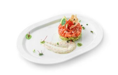 Tartar with salmon fish, avocado and red caviar decorated with microgreens on plate isolated on...