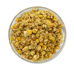 Dry chamomile flowers in bowl isolated on white, top view