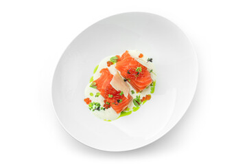 Salmon rolls and red caviar with sauce and greens on plate isolated on white background. Fish and seafood, close up, top view