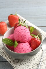 Tasty sorbet with strawberries and mint served on grey wooden table, closeup