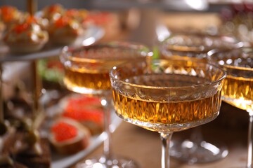Buffet menu. Glasses of sparkling wine on table, closeup
