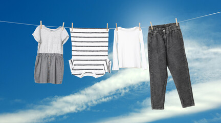 Different clothes drying on washing line against blue sky