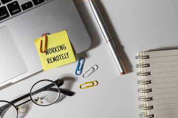 Office Note “Working Remotely” Set on Office Desk – Remote Work Concept