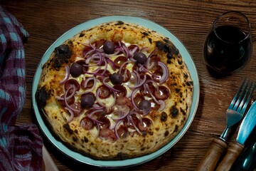 Authentic Brazilian pizza with calabresa sausage and onions baked in a wood-fired oven. Vera Neapolitan pizza