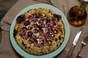 Authentic Brazilian pizza with calabresa sausage and onions baked in a wood-fired oven. Vera Neapolitan pizza