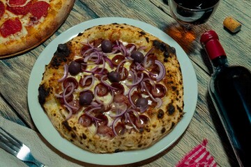 Authentic Brazilian pizza with calabresa sausage and onions baked in a wood-fired oven. Vera Neapolitan pizza