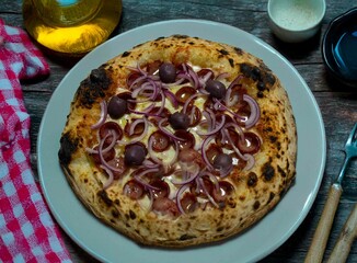 Authentic Brazilian pizza with calabresa sausage and onions baked in a wood-fired oven. Vera Neapolitan pizza