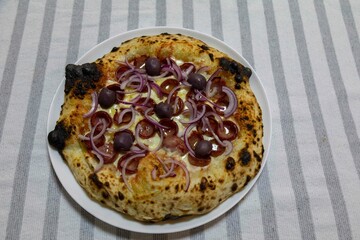 Authentic Brazilian pizza with calabresa sausage and onions baked in a wood-fired oven. Vera Neapolitan pizza