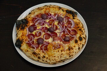 Authentic Brazilian pizza with calabresa sausage and onions baked in a wood-fired oven. Vera Neapolitan pizza