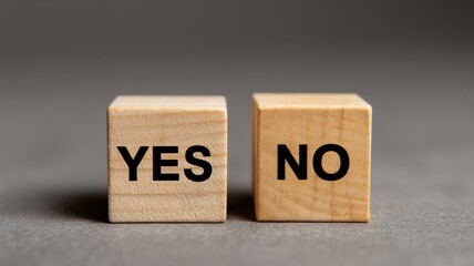 Two wooden blocks display the words "YES" and "NO" against a neutral background.
