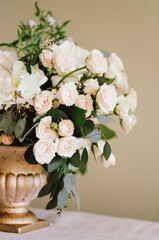 Beautiful floral arrangement in a vase showcasing soft pink roses and greenery for a romantic setting