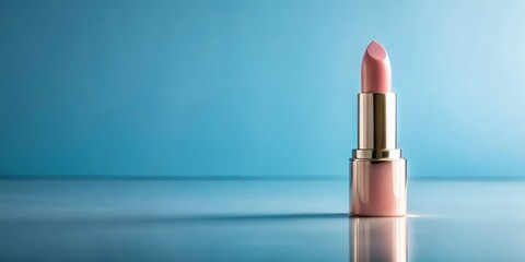 A single tube of pale pink lipstick rests on a reflective surface against a serene blue backdrop