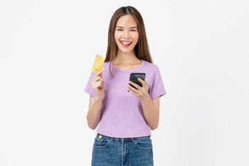 Beautiful Asian woman holding credit card and using smartphone on white background.