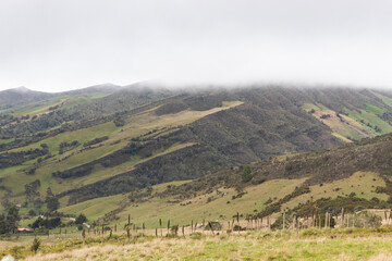 colombian countryside scene with grass cloudy mountains