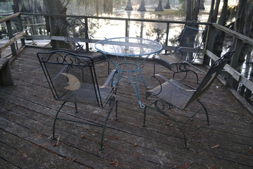 Lakeview deck with iron chairs and table at Caddo Lake, Texas