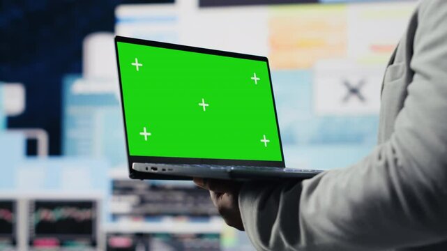 African american entrepreneur using copy space display on device, reviewing big data insights on dashboard. Young adult showcasing strategic decision making, productivity and growth. Camera B.