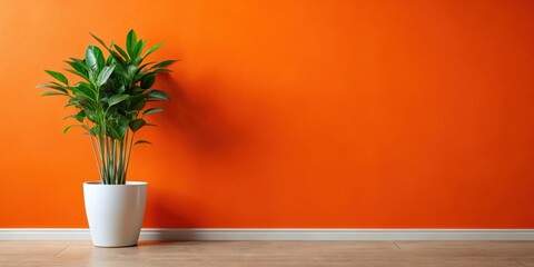 Fototapeta premium Vibrant Orange Wall with a Lush Green Plant in a Simple White Pot, Creating a Minimalist and Modern Interior Design Aesthetic