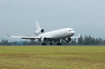 Cargo plane landing on a cloudy day