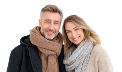 A cheerful couple dressed in warm winter scarves. smiling at the camera against a plain white background. conveying warmth and connection. ideal for seasonal promotions or relationship themes