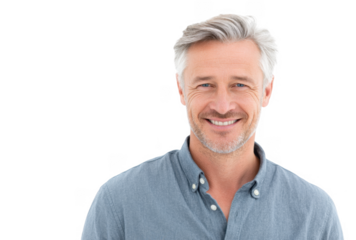 A smiling middle-aged man with gray hair. wearing a casual blue shirt. stands against a plain white background. exuding confidence and approachability. ideal for professional or lifestyle imagery