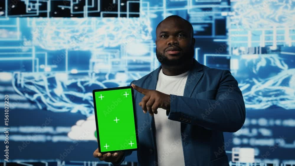 Poster african american tech engineer reviews algorithmic data next to mockup, holding a tablet surrounded 