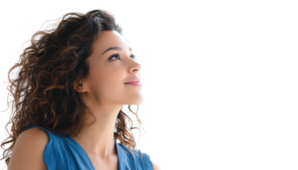 A young woman with curly hair gazes upward with a serene expression. standing against a bright white background. evoking feelings of hope and inspiration