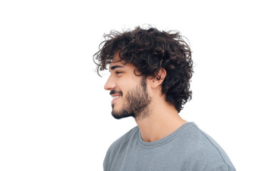 Fototapeta premium Profile view of a young man with curly hair and a beard. smiling gently against a plain background. conveying a sense of confidence and approachability. suitable for lifestyle or portrait photography