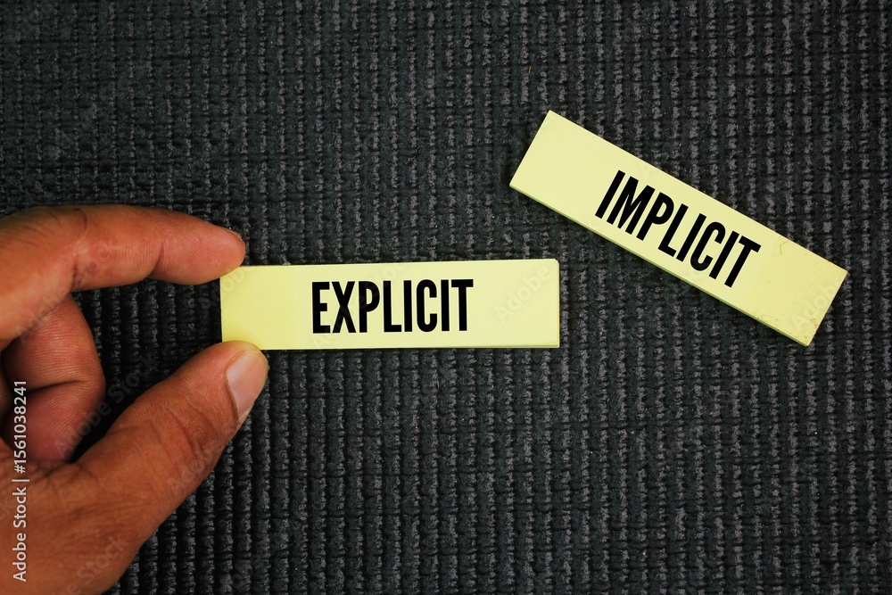Poster paper with the words explicit and implicit. motivational words positive and negative. contrasting te