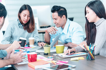 Obraz premium Creative design office center working teamwork. Happy business people partner plan strategy organization research people together at diversity office using laptop, smartphone company conference room