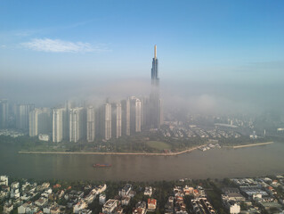View of Landmark Building and Saigon River sunny in morning fog 