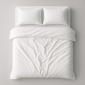 Top view of a neatly made double bed with white pillows and blanket on a light background, emphasizing comfort, cleanliness, and minimalist bedroom interior design aesthetics

