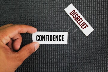 Two opposite words Confidence and Disbelief. confidence being a belief in one's own abilities and disbelief being a lack of belief or doubt.