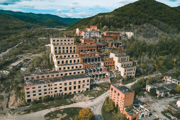 Aerial view of an abandoned mining and processing plant in a mountainous region