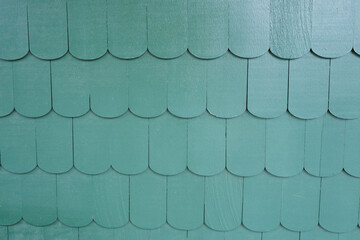 old-fashioned scalloped cedar siding texture on a building wall