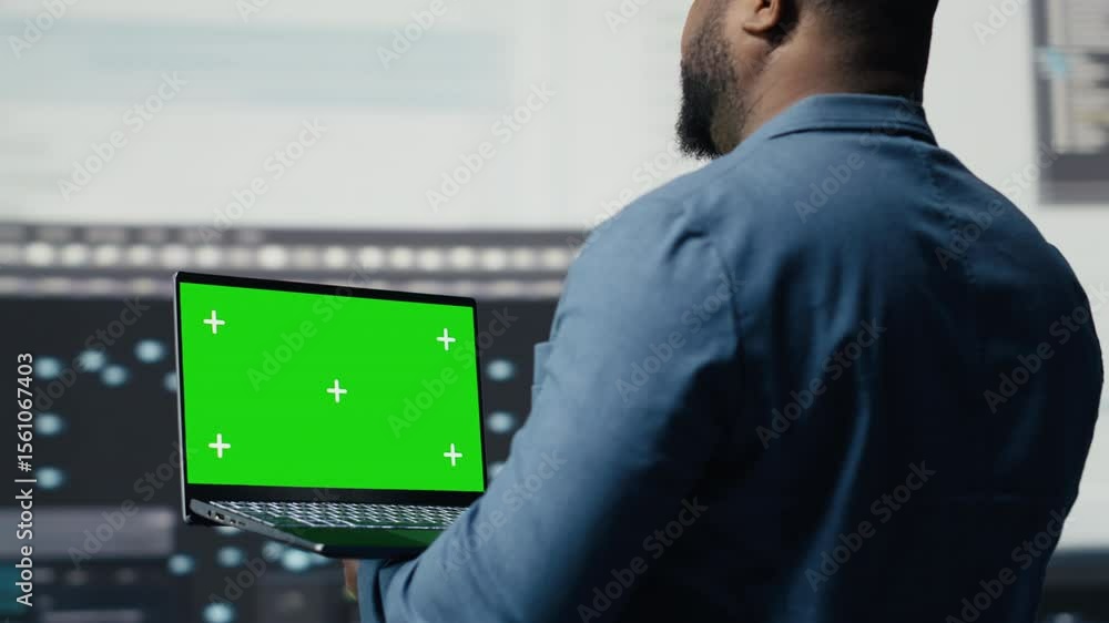 Poster african american it specialist shows laptop with chroma key screen and terminal window in the backgr