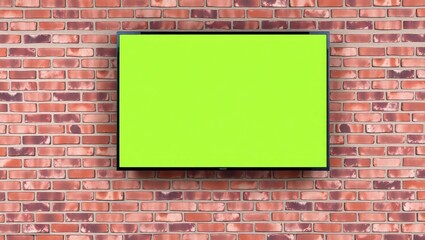 A realistic widescreen flat TV mounted on a red-brown brick wall. The television screen displays a clean, vivid green screen (chroma key) ready for compositing. The bricks are arranged in a horizontal