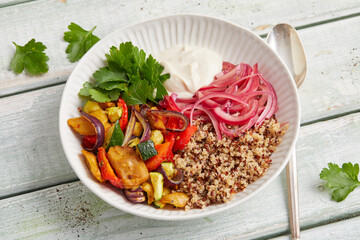 Seitan quinoa yogurt bowl with roasted vegetables and herbs