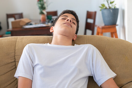 A young man is sleeping on a couch