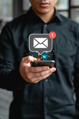 Person holding smartphone with email notification.