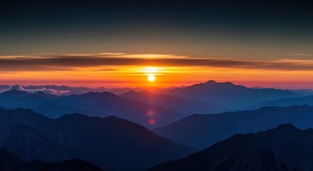 Fototapeta premium A vista of mountains at dawn with a vibrant orange sky and rising sunlight