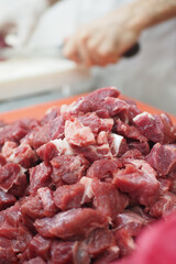 Freshly cut meat ready for preparation in a busy kitchen