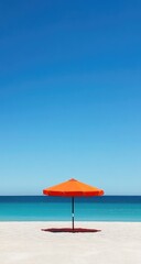 Bright orange beach umbrella on white sand, turquoise water, clear blue sky