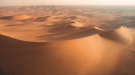 Aerial drone footage of desert sand dunes with natural textures and long shadows