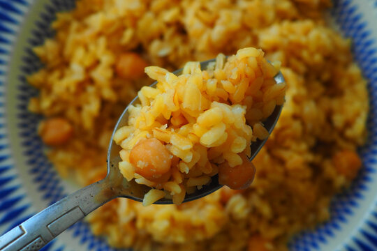 Delicious yellow rice served with chickpeas and spices - Powered by Adobe