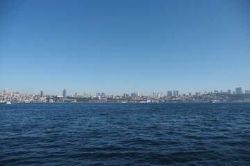 View of city skyline by the calm sea during daytime