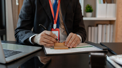 a businessman is reviewing accounting and financial statistics documents in his private office, the statistician prepares various charts and documents for a meeting